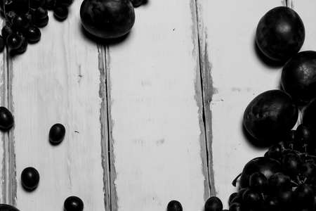 Prunes and grapes on the tableの写真素材