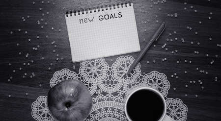 Notepad for entries on the table. Handle and paper on a wooden sの写真素材