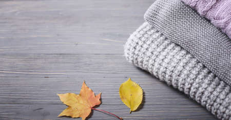 Autumn knitted sweaters and leavesの写真素材