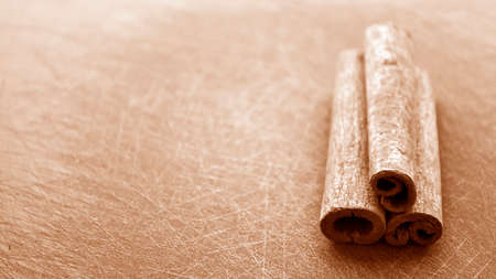 Cinnamon sticks lying on the table in the kitchen. Seasoning for