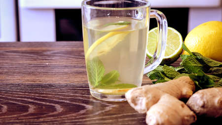 Drink from the lemon on the table. Lemon and ginger drink.