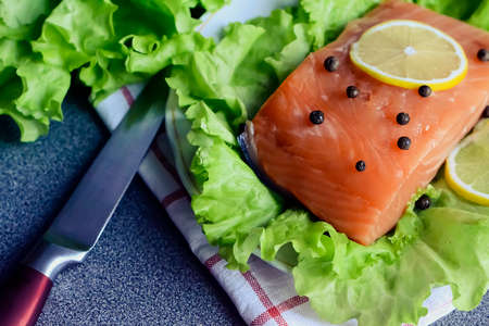 A piece of fish with vegetables on the table. Healthy food