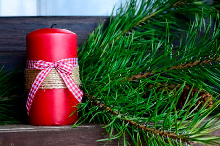 Candle on the table near the Christmas tree. Christmas present.の写真素材