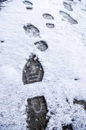 Dirty footprints in the snow in the winter. の写真素材