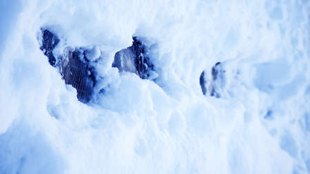 Dirty footprints in the snow in the winter. 