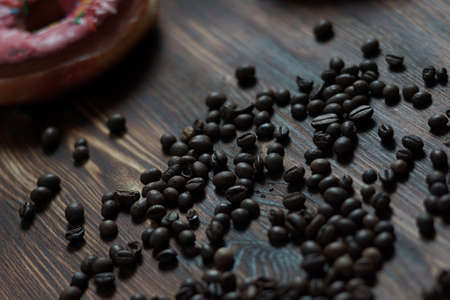 Sweet donuts and tea on a dessert on a wooden texture backgroundの写真素材
