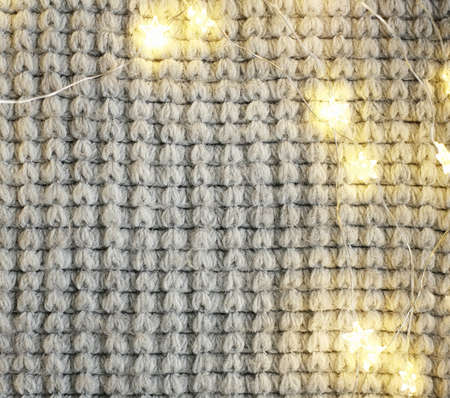 Christmas bright garlands on a wooden light backgroundの写真素材