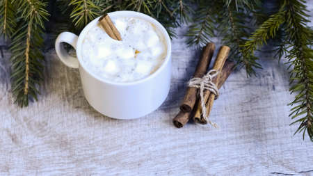 Coffee with marshmallows at the Christmas tree. Festive warmingの写真素材