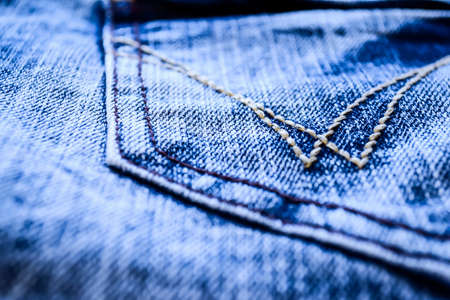 Denim clothes lying on the table with the glasses.