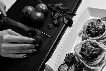 Dinner in the restaurant. Hands plates of food. Fork for eating.の写真素材