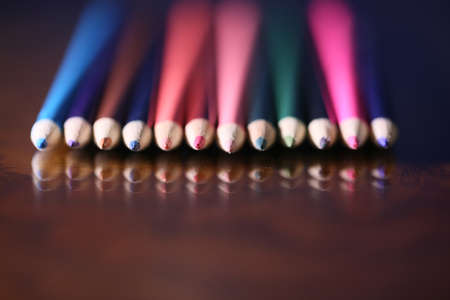 Multicolored pencils on the table. A stack of colored pencils tiの写真素材