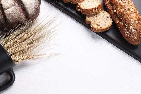 Fresh baked bread with ears of wheat. Wheat yellow. Breakfast isの写真素材