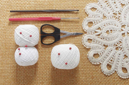 Objects for sewing. Scissors and pins. Hanks thread on mat. Pinsの写真素材