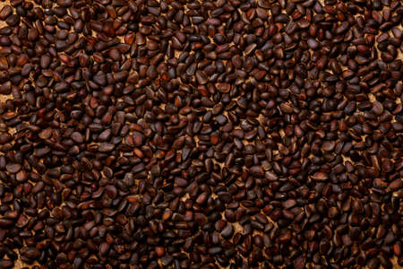 Nuts lying on the table by the handful.Tasty treats on a woodenの写真素材