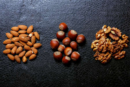 Nuts lying on the table by the handful.の写真素材