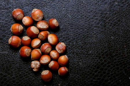 Nuts lying on the table by the handful.の写真素材