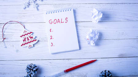 Workplace with a diary, decorations and gifts. New Year's list of gifts.の写真素材