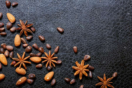 Nuts lying on the table by the handful.Tasty treats on a woodenの写真素材
