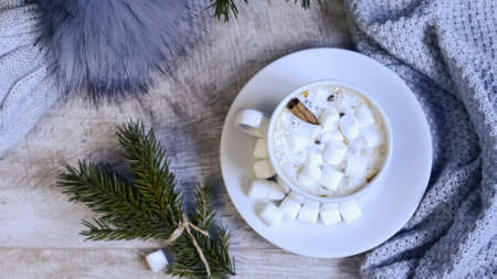 Coffee with marshmallows at the Christmas tree. Festive warmingの写真素材