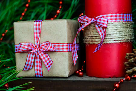 Candle on the table near the Christmas tree. Christmas present.の写真素材