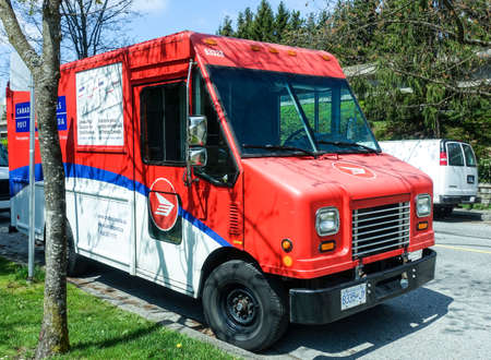 May 2018- Canada Post Delivery truck parking on the side of the street in Burnaby, BC Canada