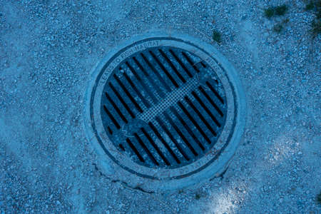 Aerial view of a manhole cover on the ground in winter.の写真素材