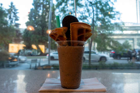 Chocolate waffle in plastic cup on table in coffee shop.の写真素材