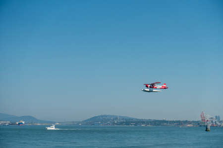Airshow with aircraft flying over water.