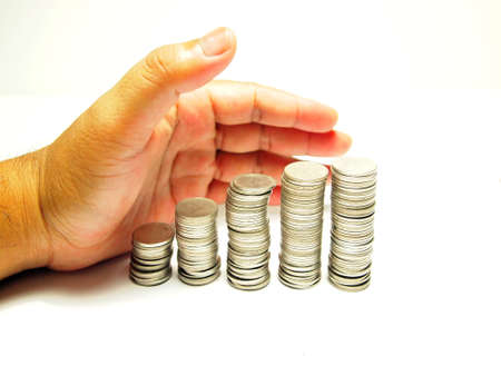 Concept Coins Stack and Hand isolated on white backgroundの写真素材
