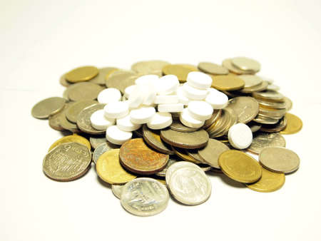 Concept Coins Stack and Aspirin isolated on white background の写真素材