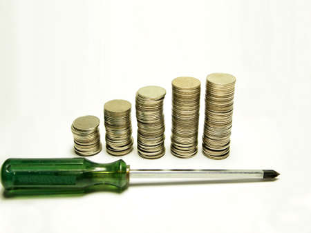 Money concept going up and Screwdriver isolated on white background         の写真素材