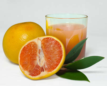 Grapefruit, juice and leavesの写真素材