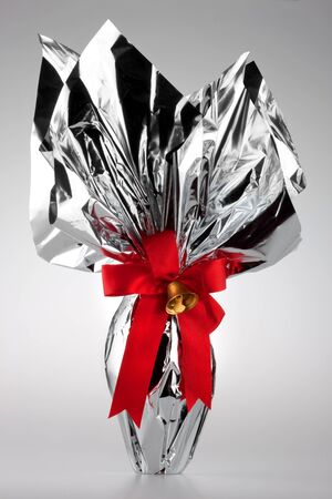 An Easter egg with red ribbon and bellの写真素材
