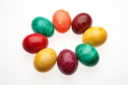 Eight colored eggs on a white backgroundの写真素材