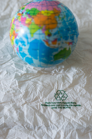 Recycle sign on gross paper and the world mapの写真素材