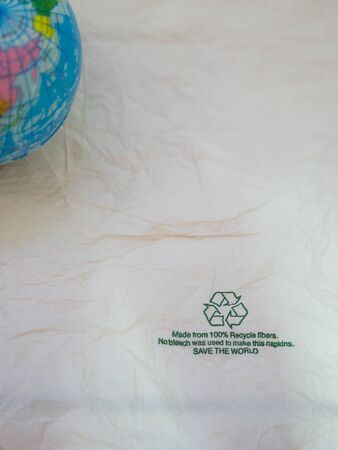 Recycle sign on gross paper and the worldの写真素材