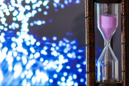 Sand clock on blurry bokeh backgroundの写真素材