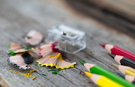 Multi color pencils and particle on wooden table, selective focus.の写真素材