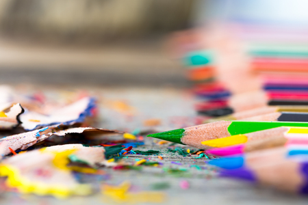 Multi color pencils and particle on wooden table, selective focus.の写真素材