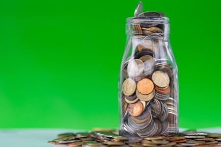 Internaltional coins money saving in bottleの写真素材