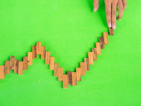 Business man create line graph by using wooden blockの写真素材