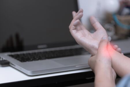 Young woman is injured from office syndrome symptomの写真素材