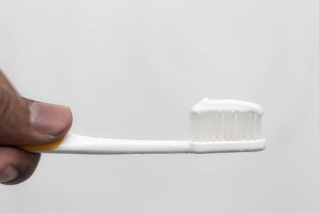 Toothbrush with toothpaste on top isolated, oral care concept