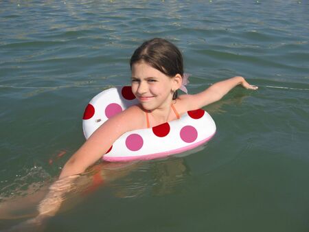 girl with swimming ring in the sea