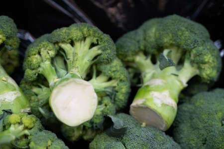 Stacked healthy green broccoli for saleの写真素材
