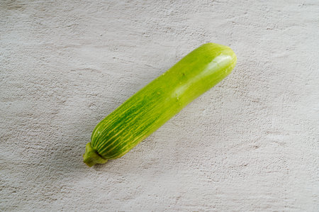 A green young pumpkin on gray backgroundの写真素材