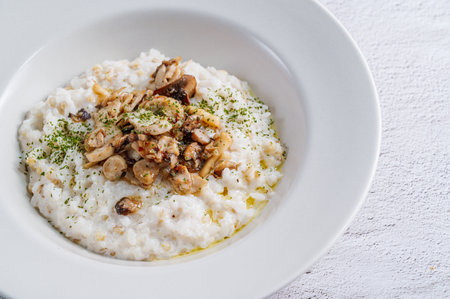 Mushroom risotto in a white bowlの写真素材