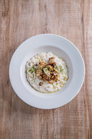 Mushroom risotto in a white bowlの写真素材
