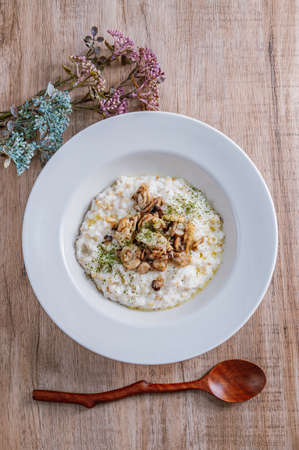 Mushroom risotto in a white bowlの写真素材