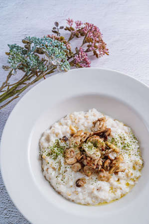 Mushroom risotto in a white bowlの写真素材